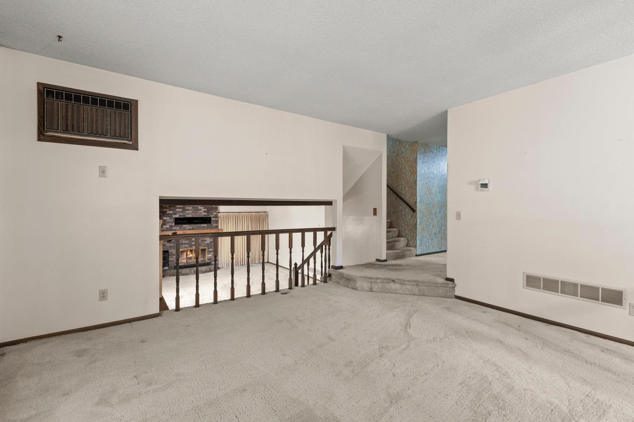 Main level living room with lower level family room perspective.jpg