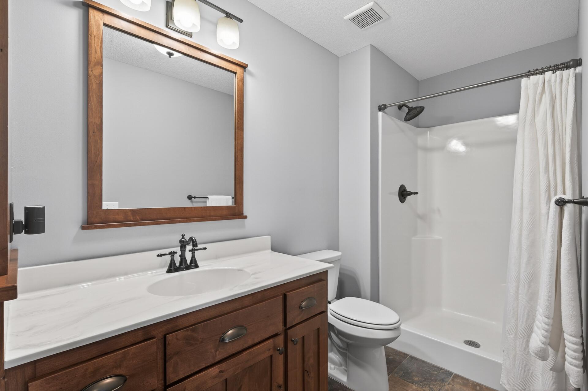 The lower level 3/4 bathroom has the same gorgeous cabinetry as the main floor.