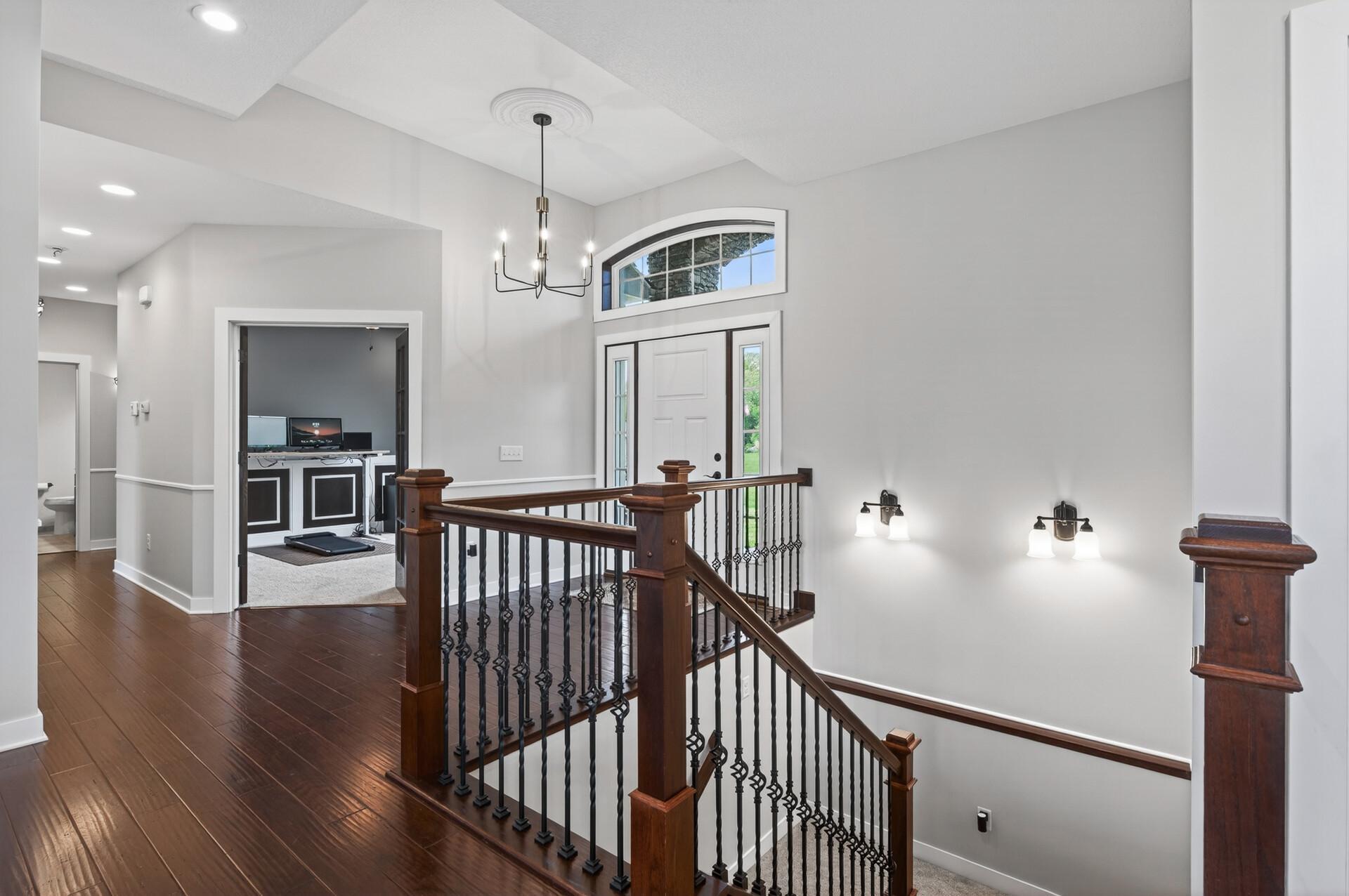Beautiful railing leads to the finished walk-out lower level.