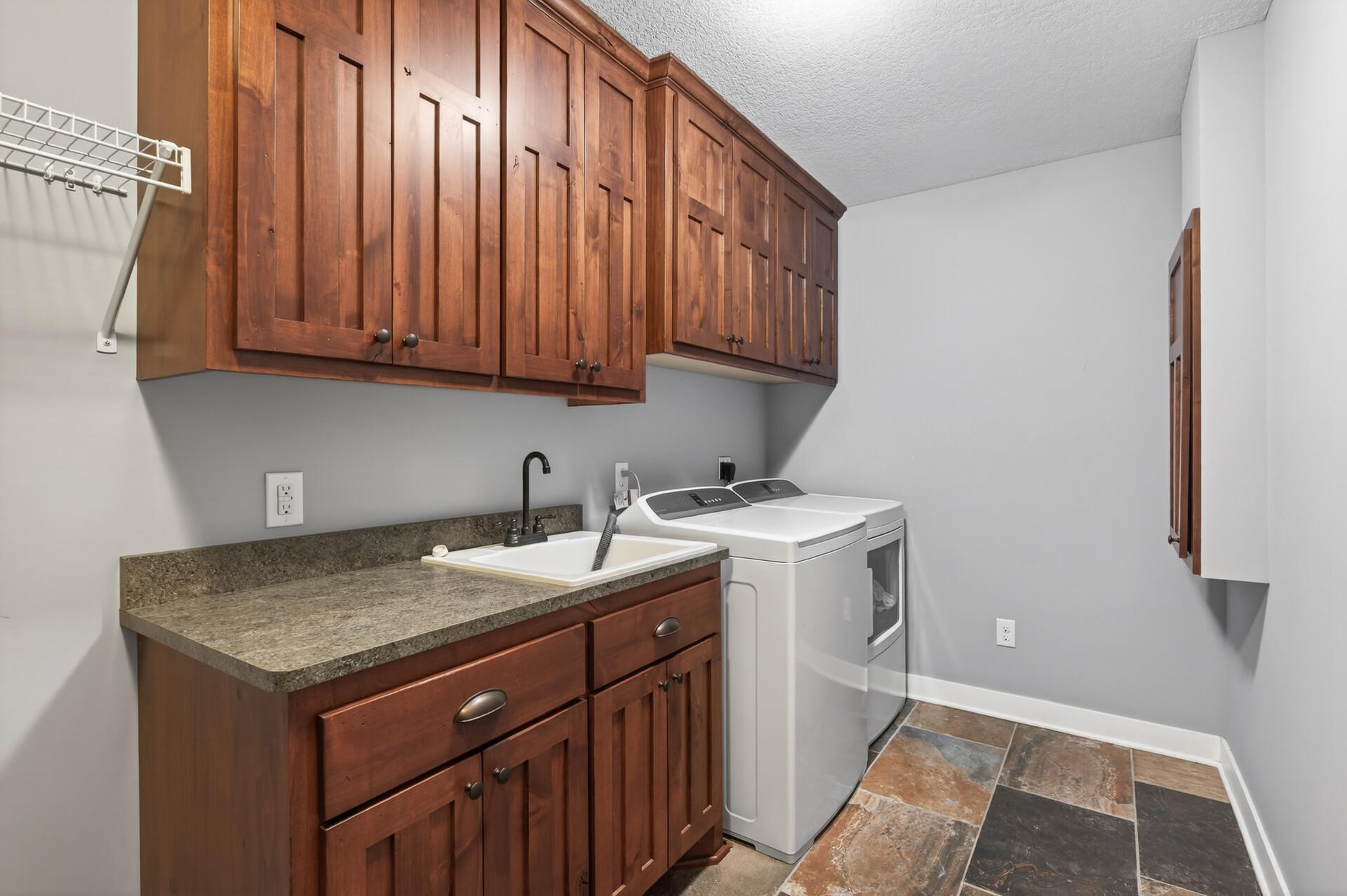 The laundry room makes keeping organized a breeze with all the storage and cabinetry.