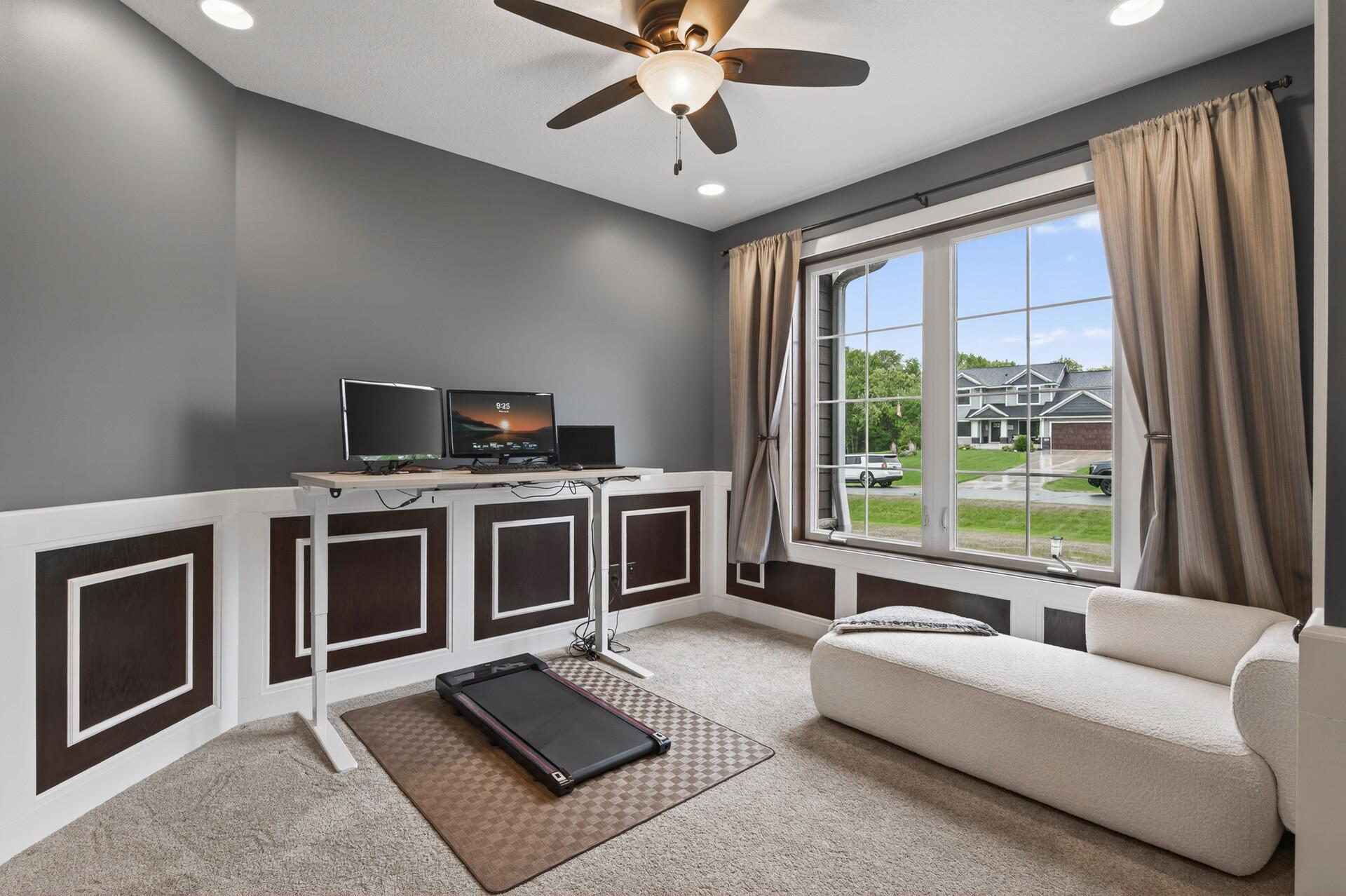 Main floor office (or 3rd bedroom) with custom wainscoting, double glass doors, large windows and a closet.
