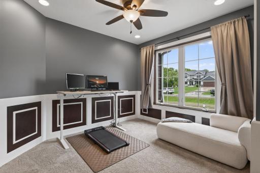 Main floor office (or 3rd bedroom) with custom wainscoting, double glass doors, large windows and a closet.