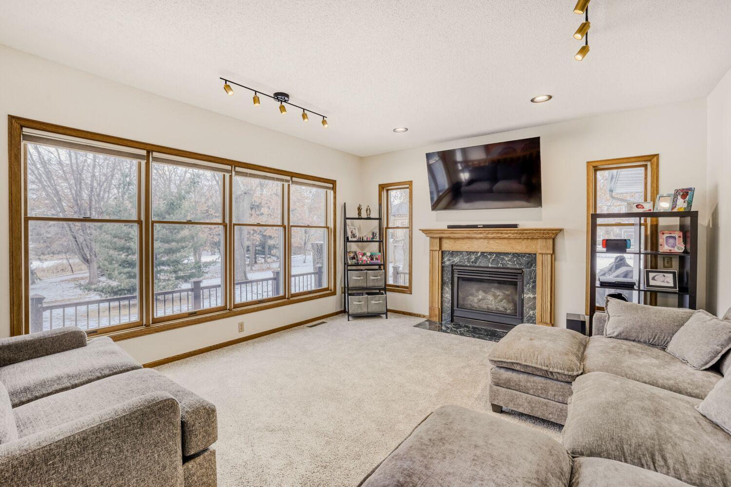 Family room off the Kitchen, dining area with a gas fireplace. Look at all the windows.