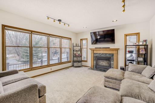 Family room off the Kitchen, dining area with a gas fireplace. Look at all the windows.