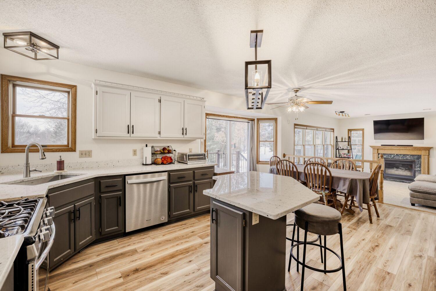 Kitchen with newer quartz countertops & stainless steel appliances.