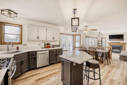Kitchen with newer quartz countertops & stainless steel appliances.