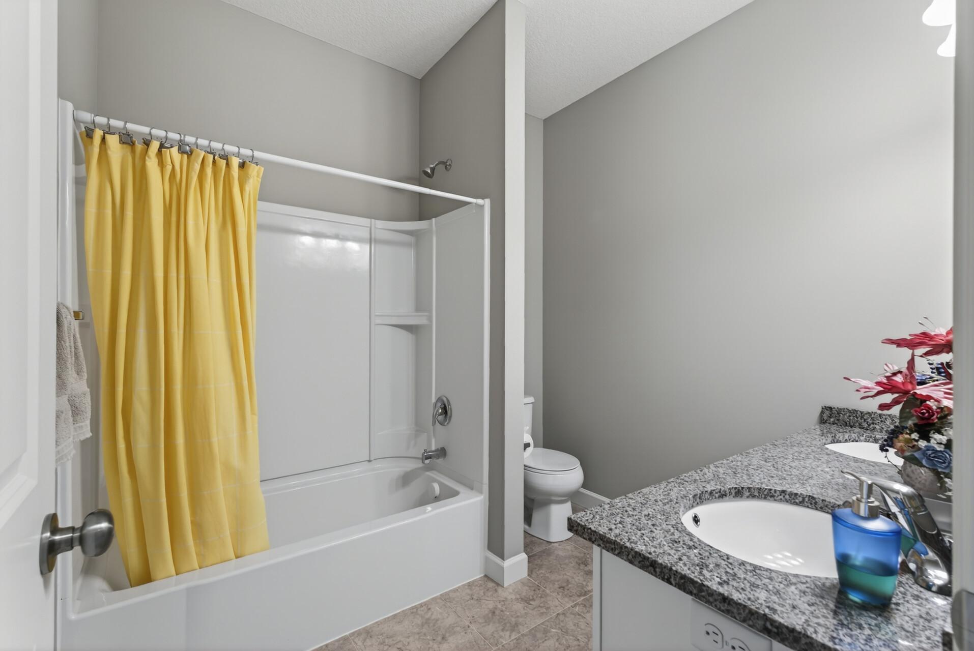 The full bathroom is conveniently located near both main level secondary bedrooms.