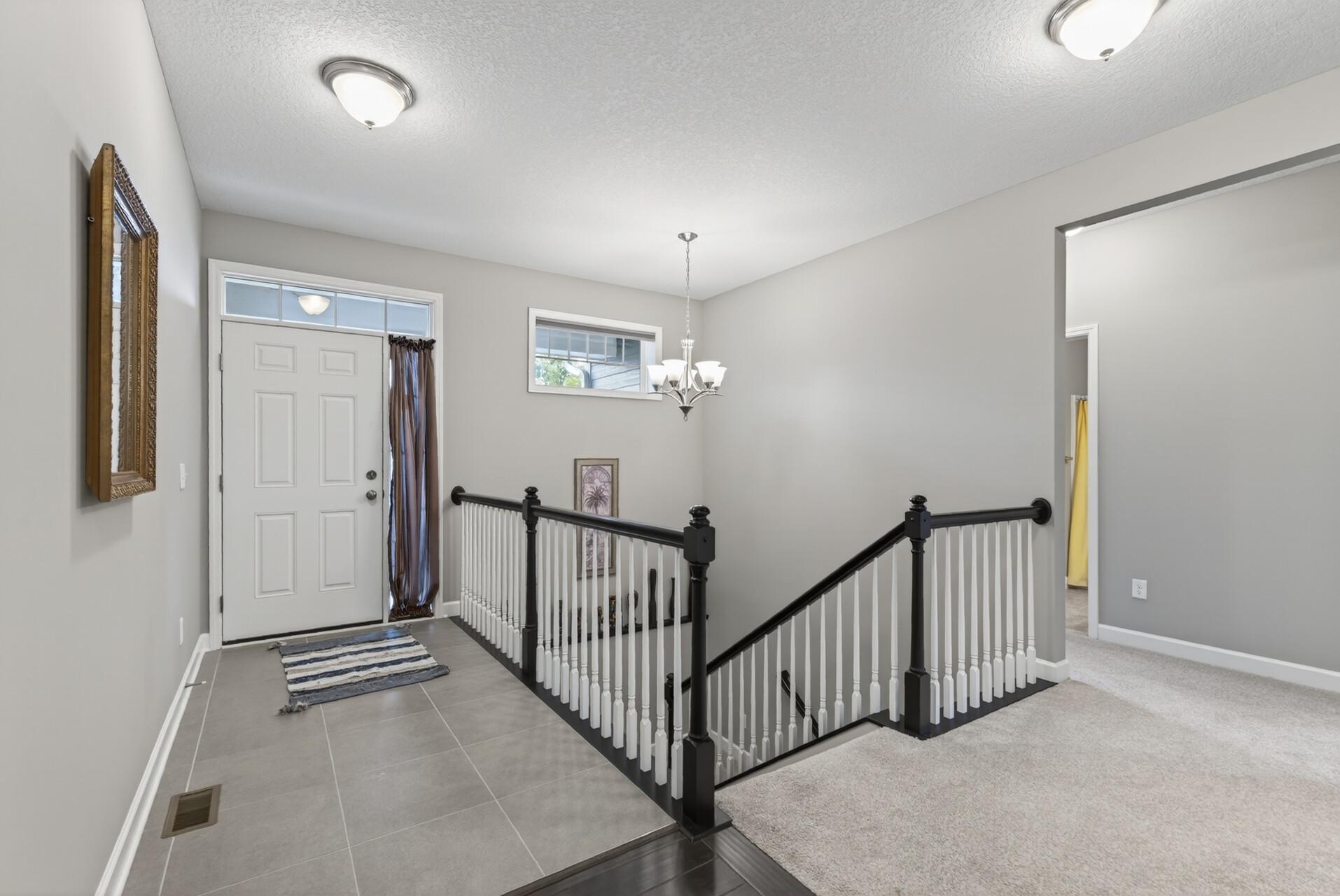 The tiled foyer creates a welcoming entrance for guests.