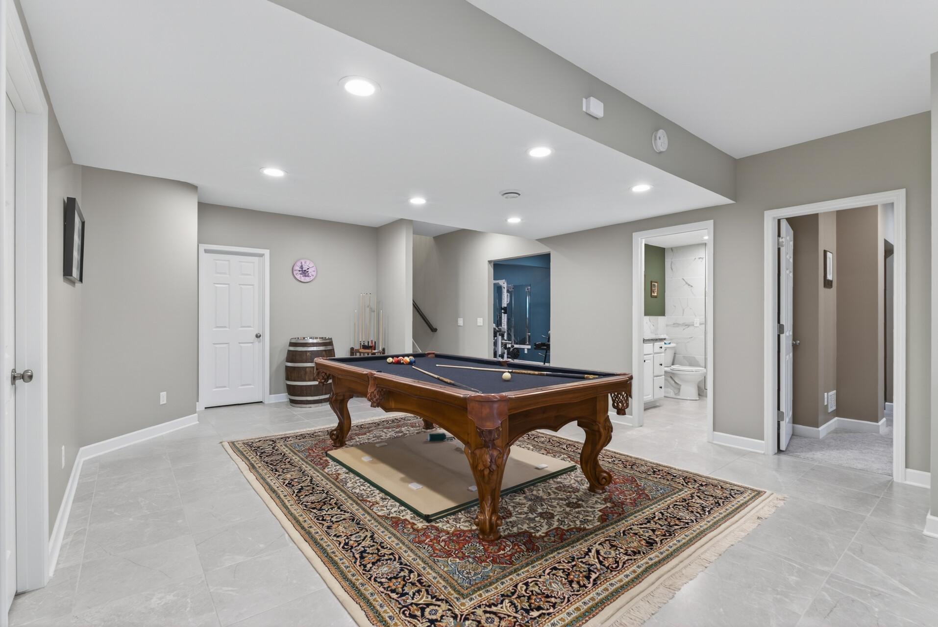 The pool table and rug will stay with the home, and there’s plenty of space for games and entertaining.
