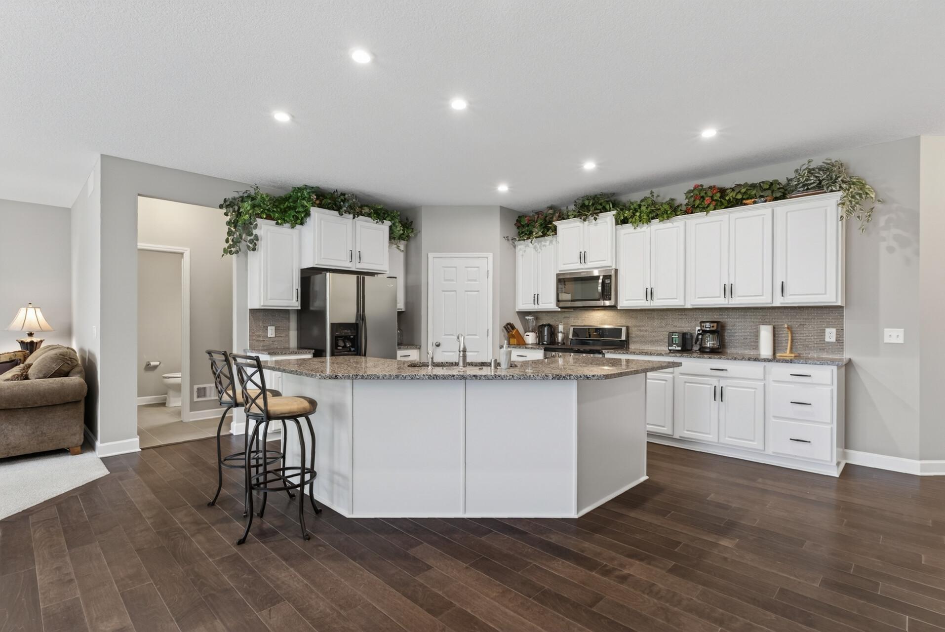 The dining area is ideal for formal meals and gatherings, while the large center island offers the perfect spot for casual dining, meal prep, or serving buffet style.