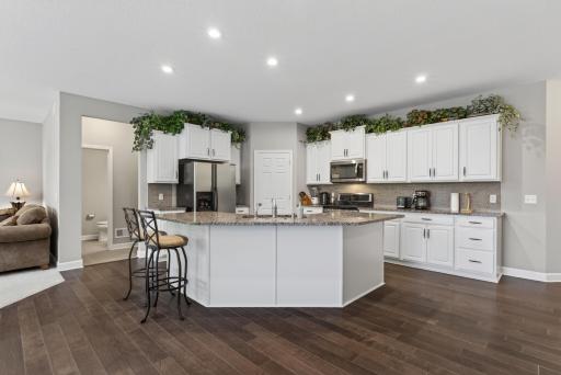 The dining area is ideal for formal meals and gatherings, while the large center island offers the perfect spot for casual dining, meal prep, or serving buffet style.
