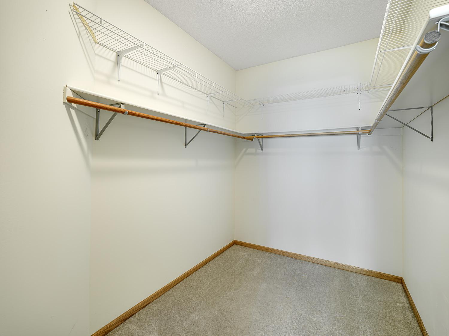 A large walk-in closet offers storage solutions for all your personal belongings.