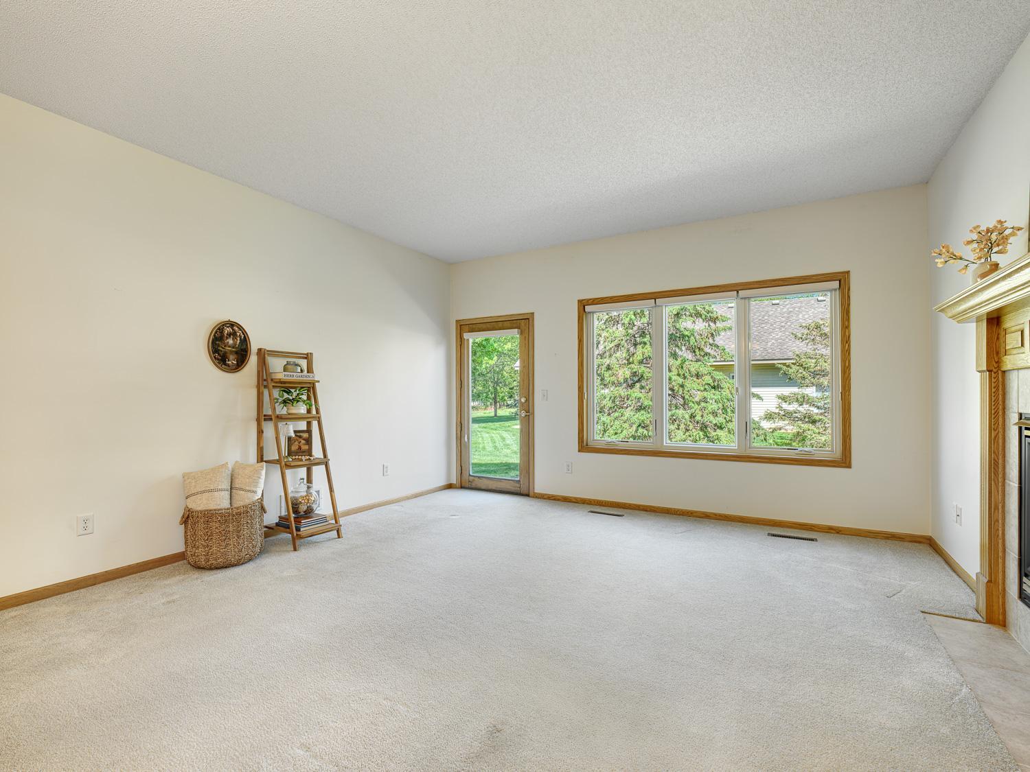 An oversized window allows you to enjoy nature from the comfort of your home, while the walk-out access leads to a private patio and serene green space.