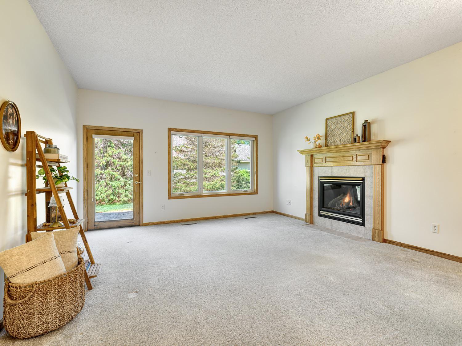 The living room is centered around a cozy gas fireplace adding warmth and a charming ambiance to the space.