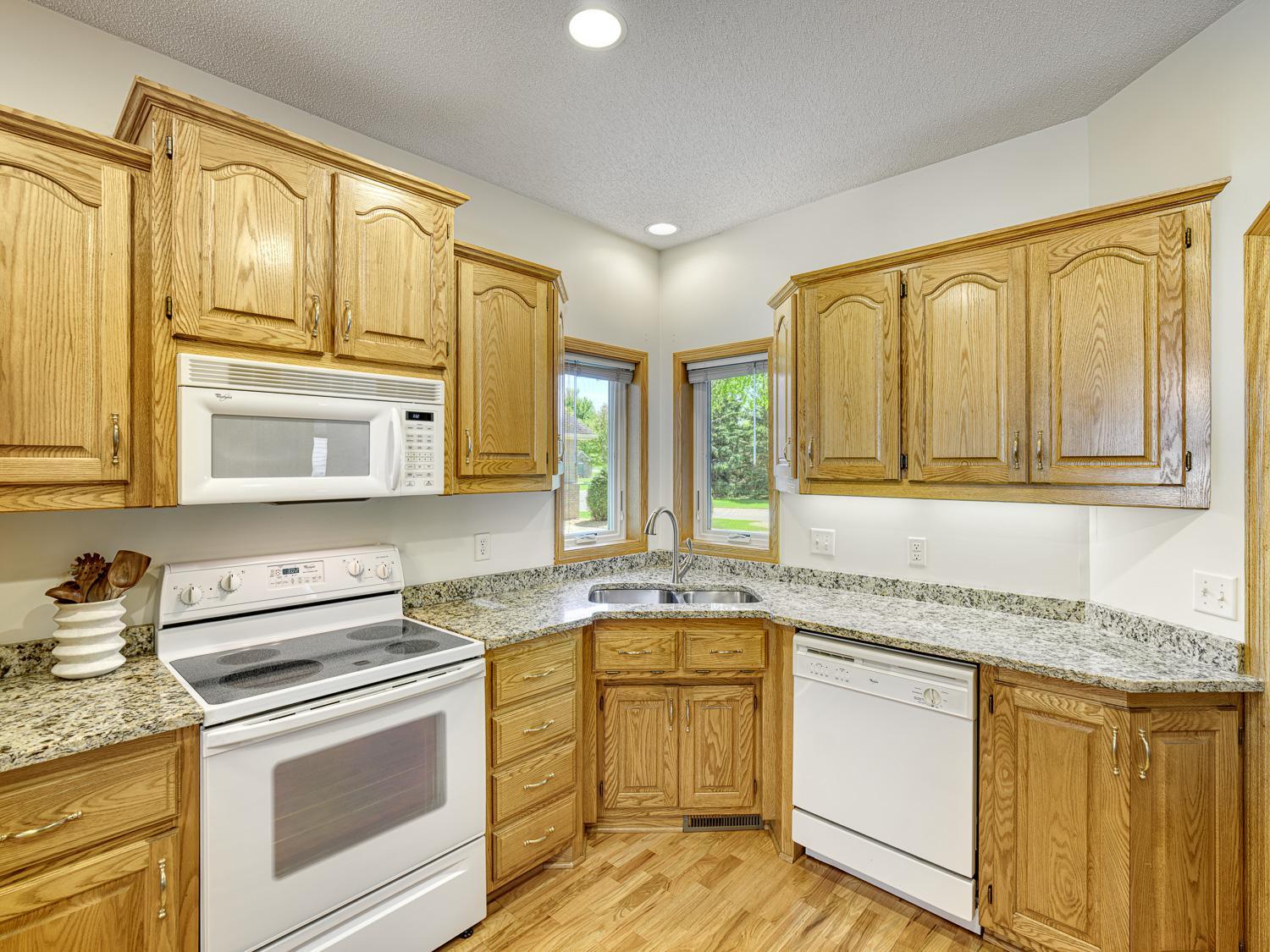 Enjoy newer granite countertops paired with undercabinet lighting for a sleek, modern touch.