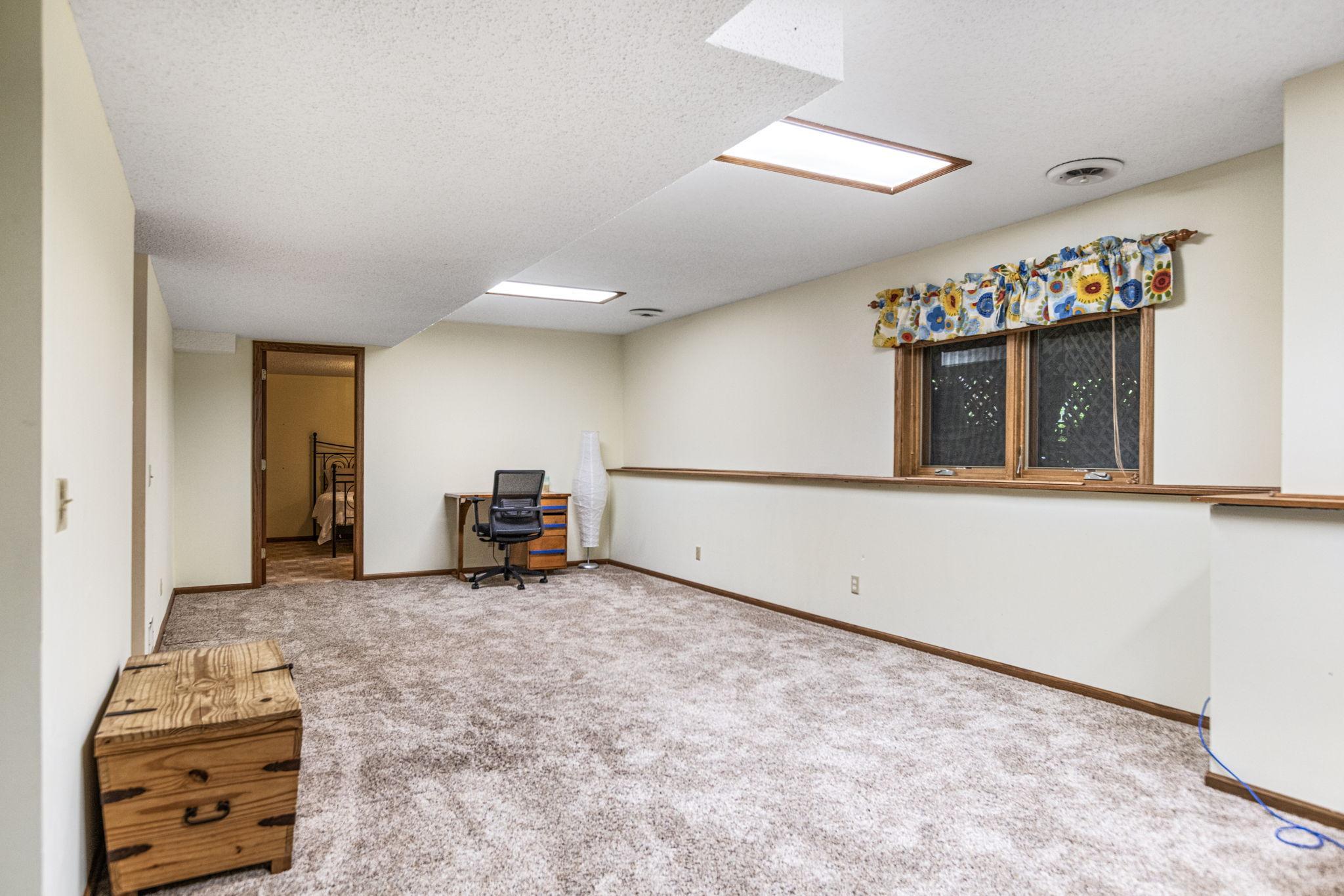 Lower level amusement room with lookout windows