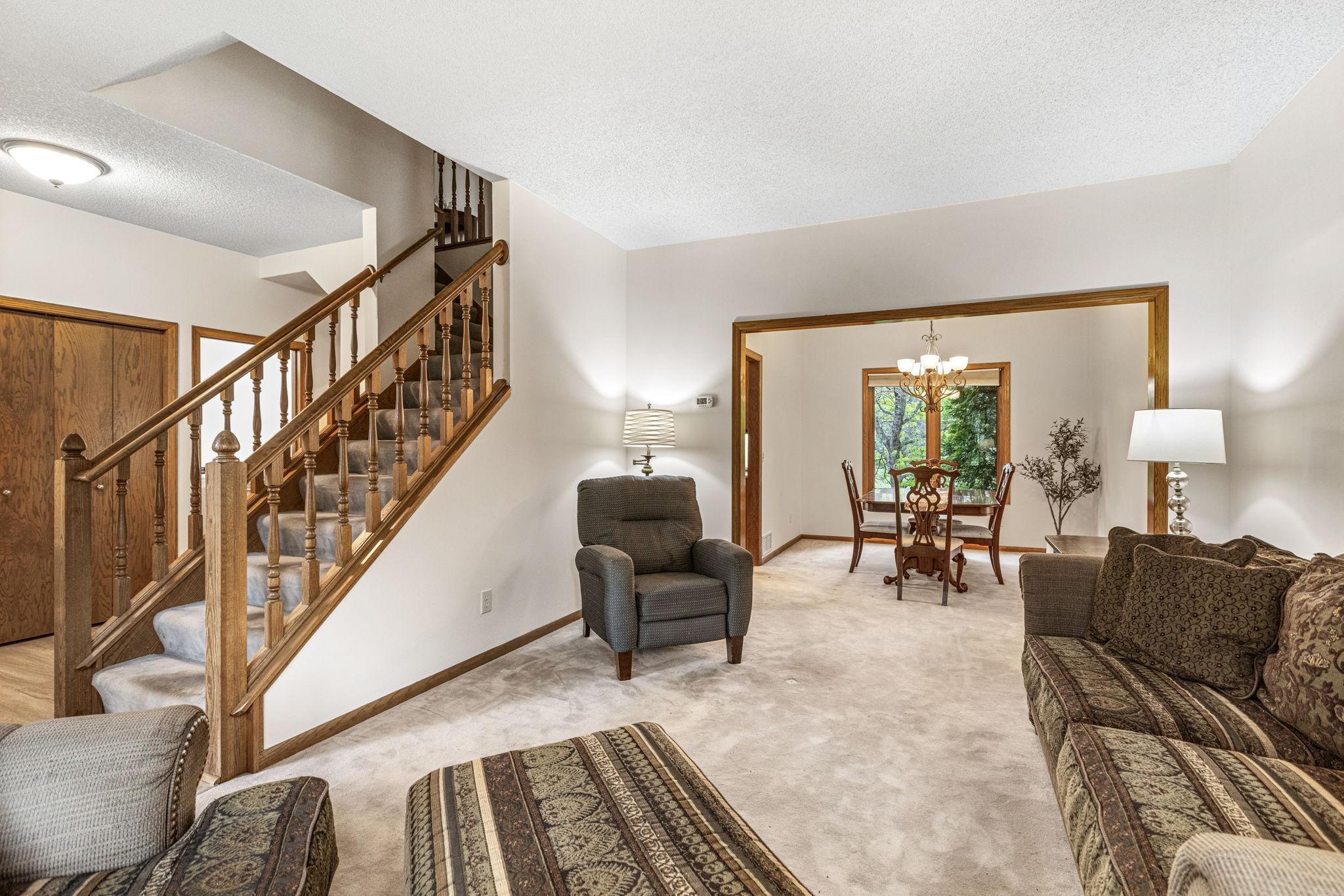 Main level living room flowing into formal dining room