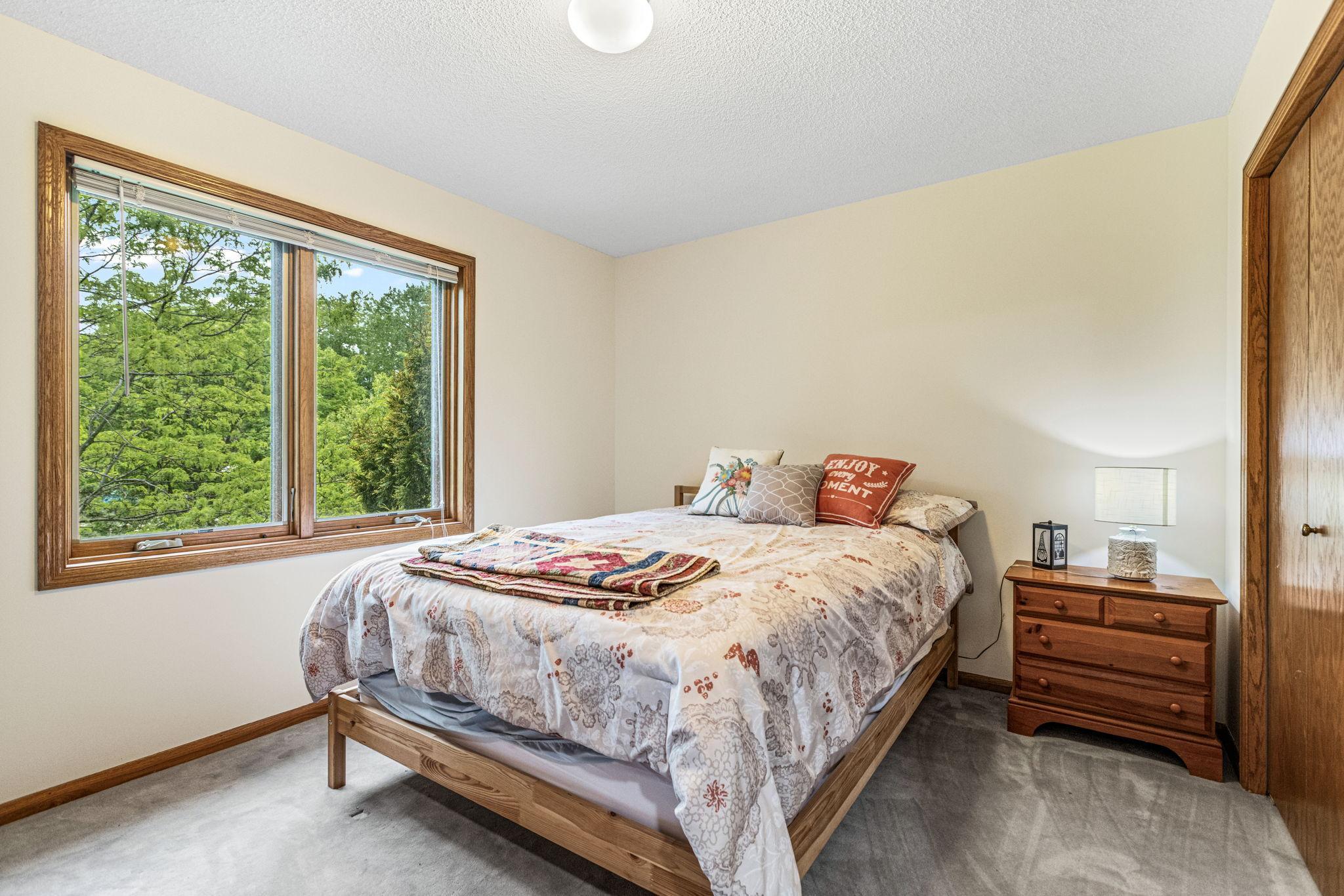 Upper level - Large second bedroom with large window and backyard views