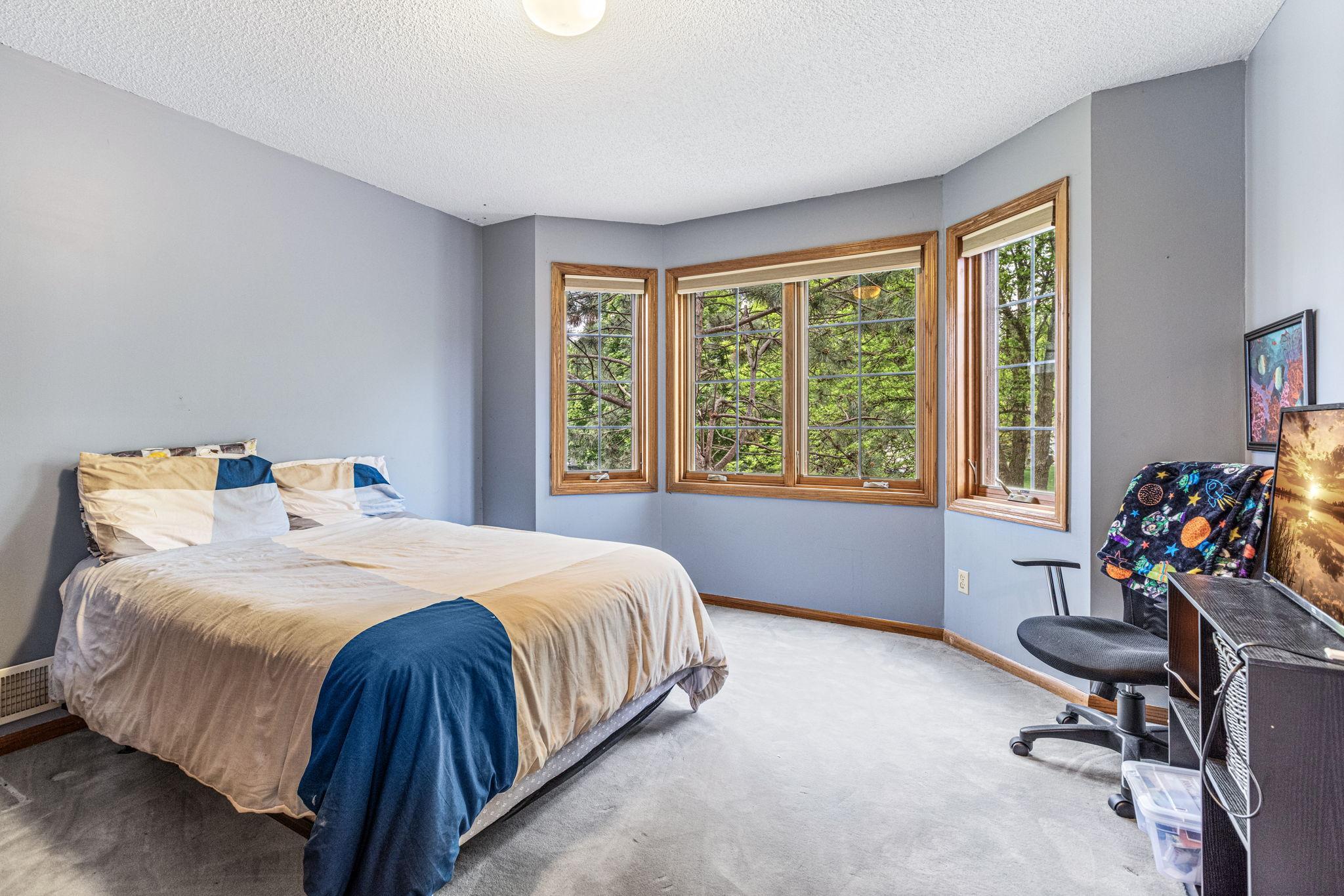 Upper level - Third bedroom with bay window and front yard views.