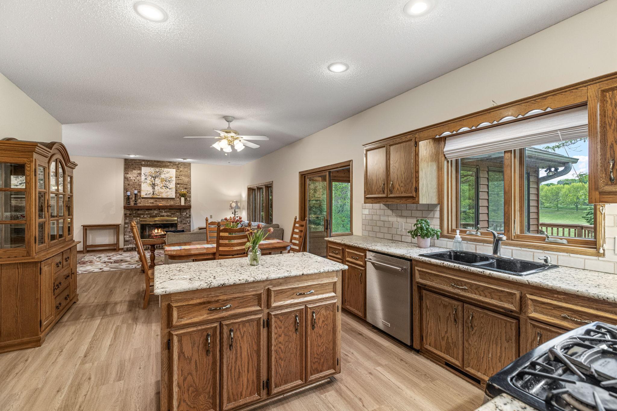Kitchen open to casual dining area and family room with fireplace