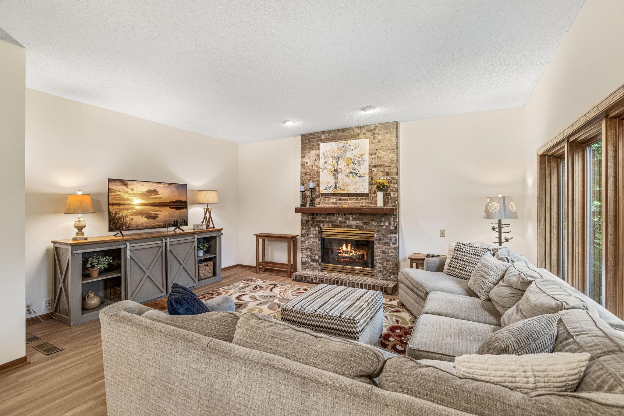 Family room with brick wood burning fireplace