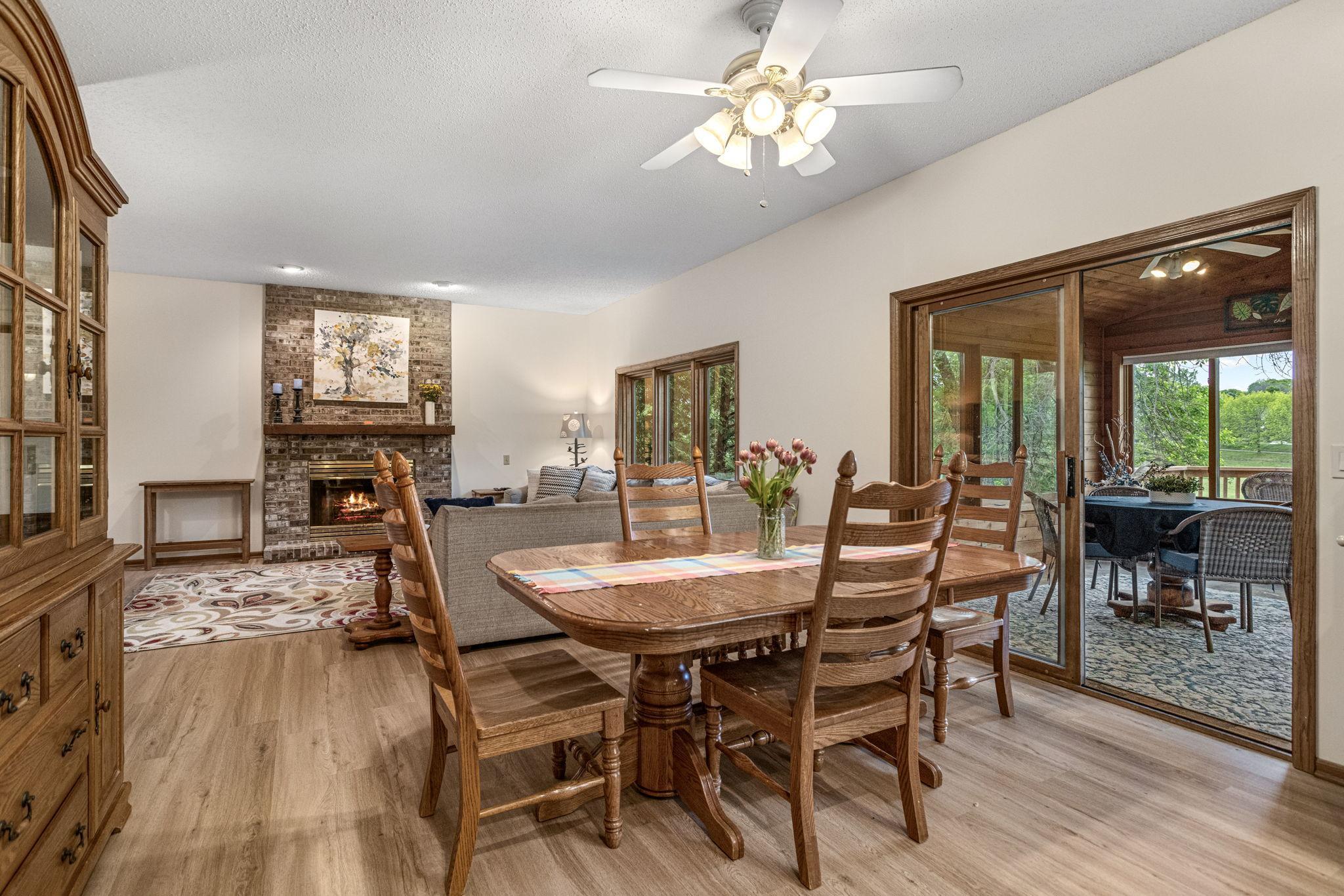 Casual dining area open to family room with brick fireplace
