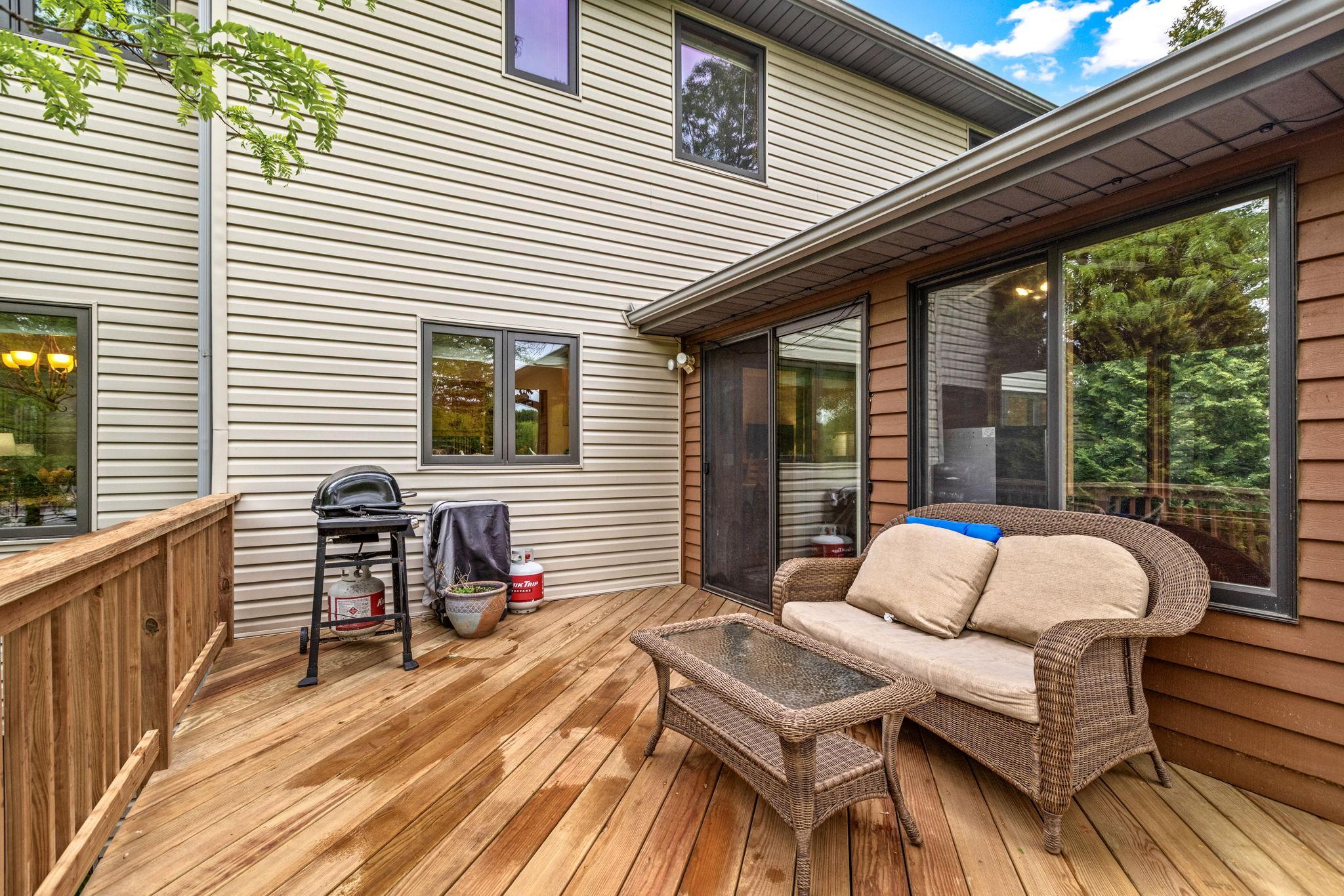 Back deck with newer decking, off the three season porch, great area for grilling.
