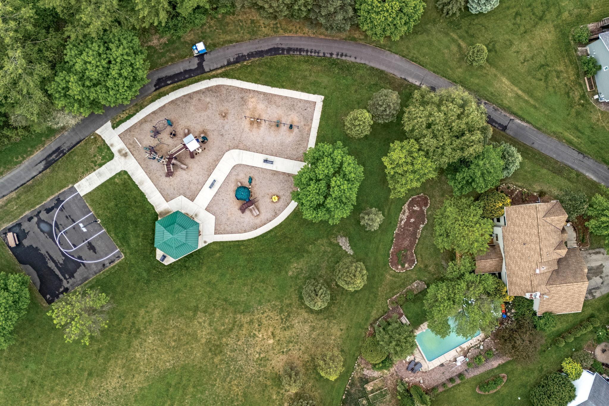 View of home, pool, park and open space.