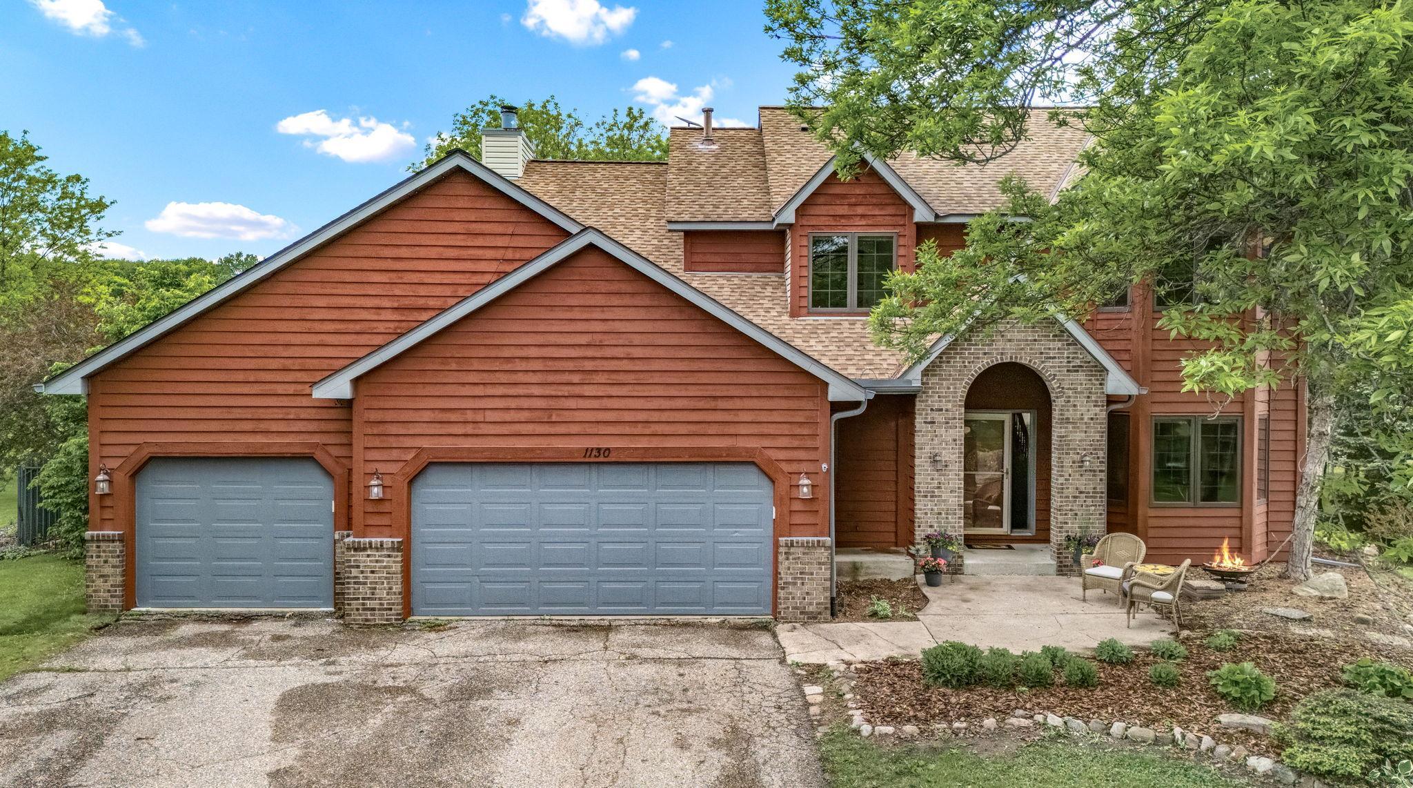 Front exterior close-up with brick entry and 3 car garage