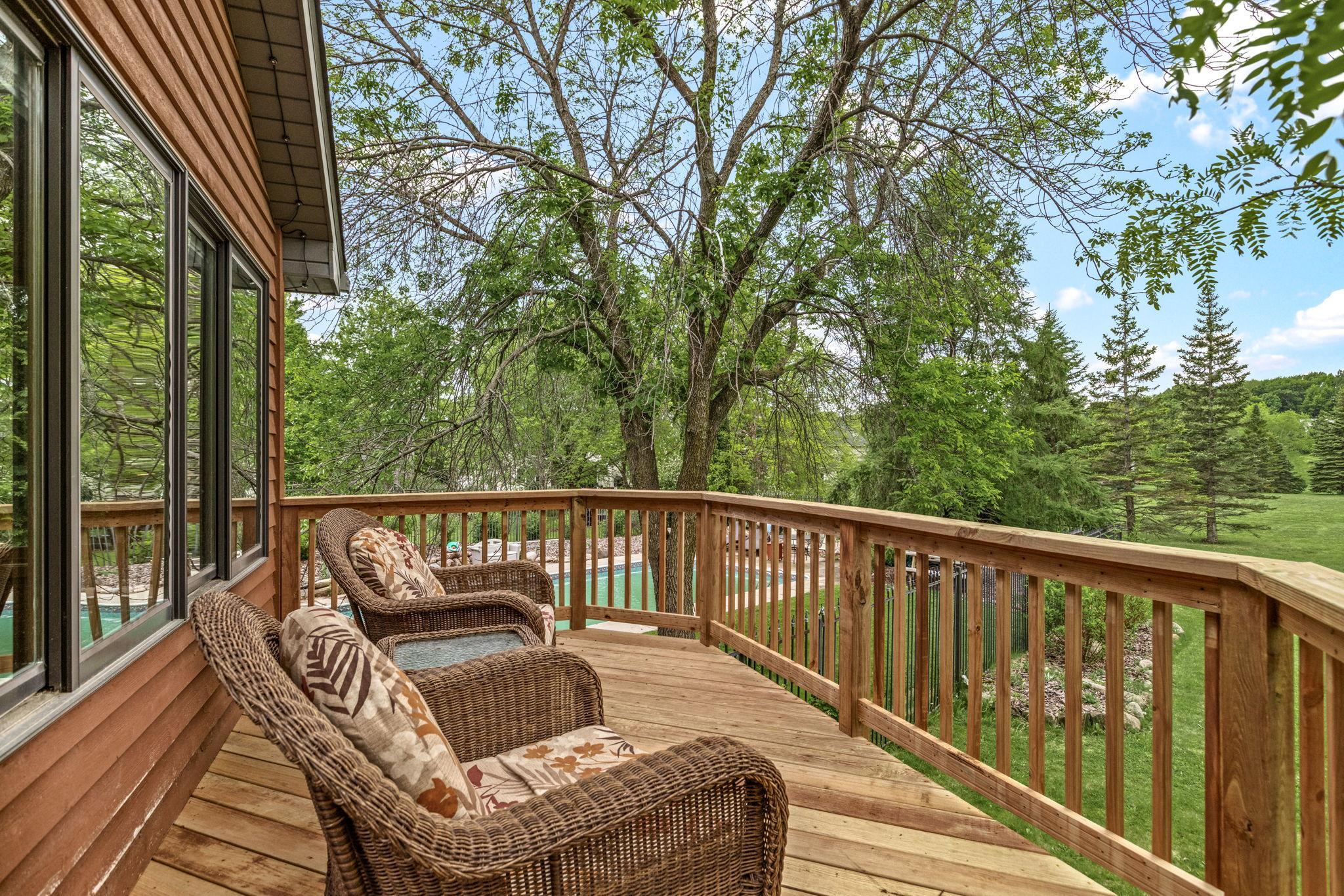 Deck area with view of the fenced in pool area