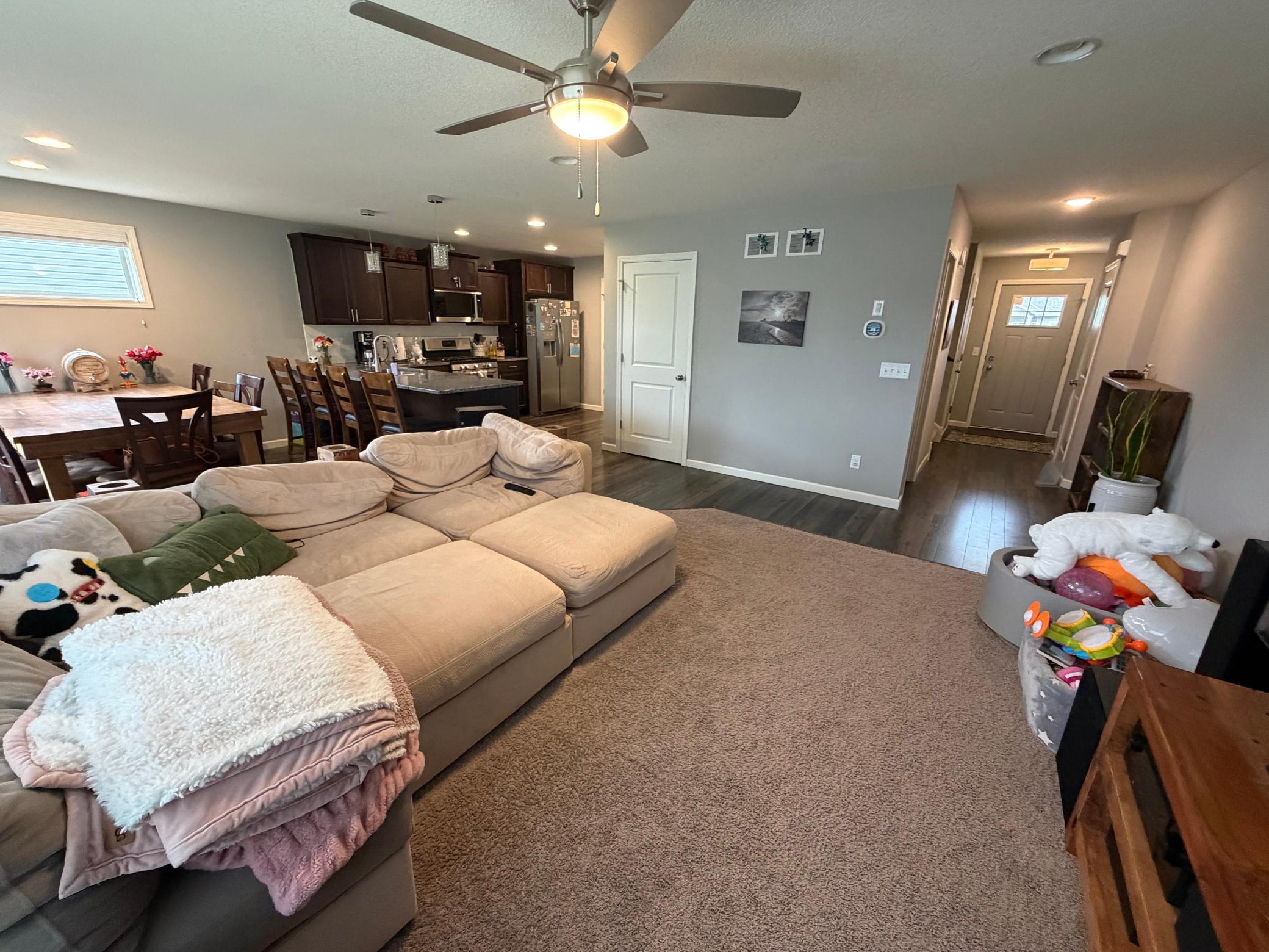 Main floor view of entry way full iving room dining and kitchen area.jpeg