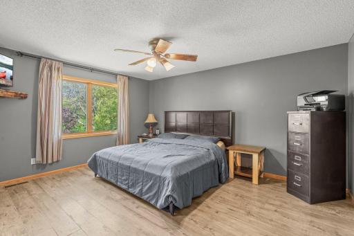Large primary bedroom overlooking the backyard
