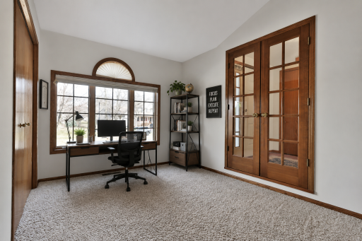 Beautiful french doors and large window in the main floor office/bedroom -virtually staged