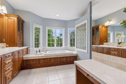 The large and private primary bath includes separate jetted tub and walk-in shower as well as double sinks