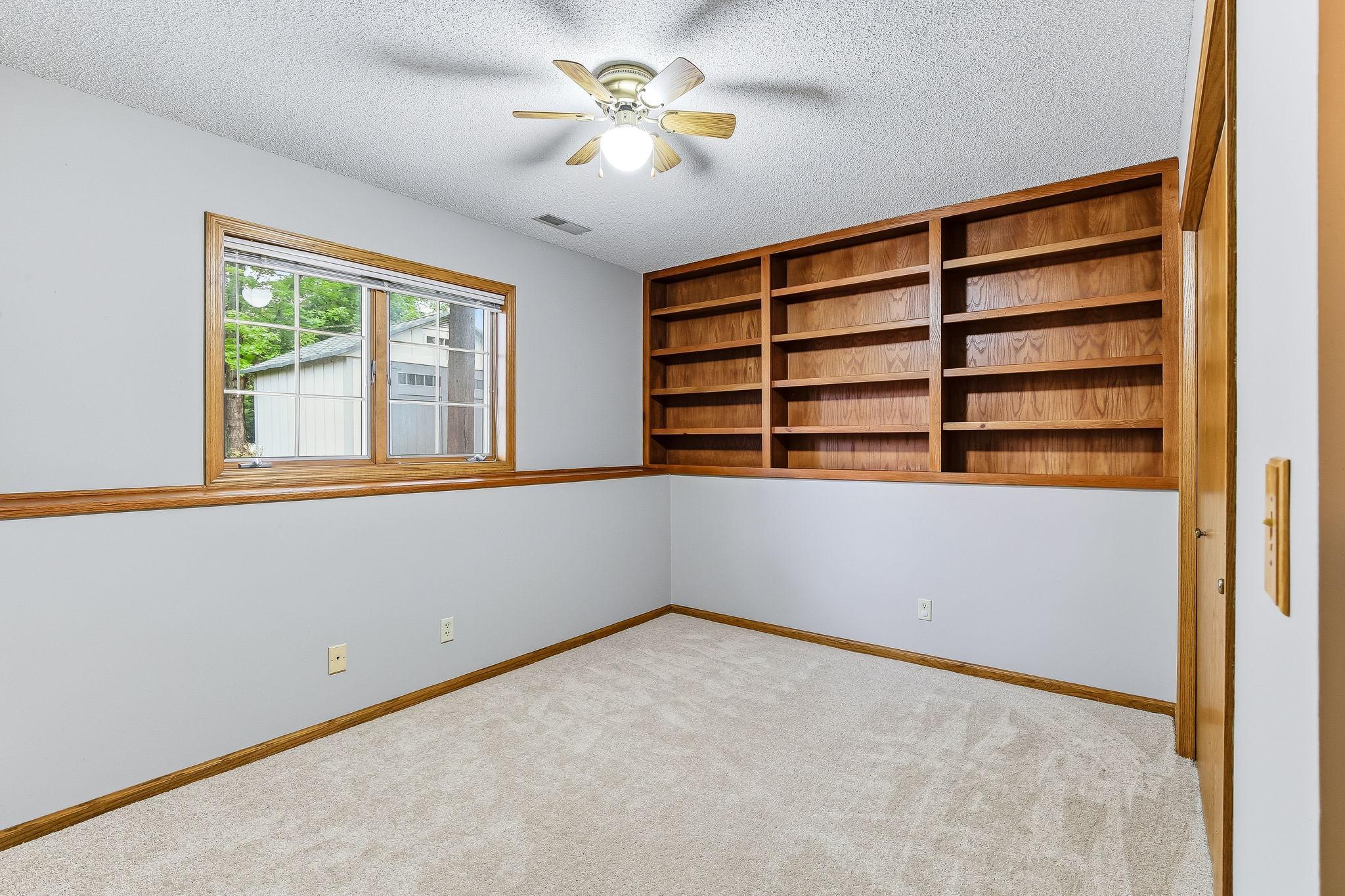 Lower level 3rd bedroom with built-in shelves