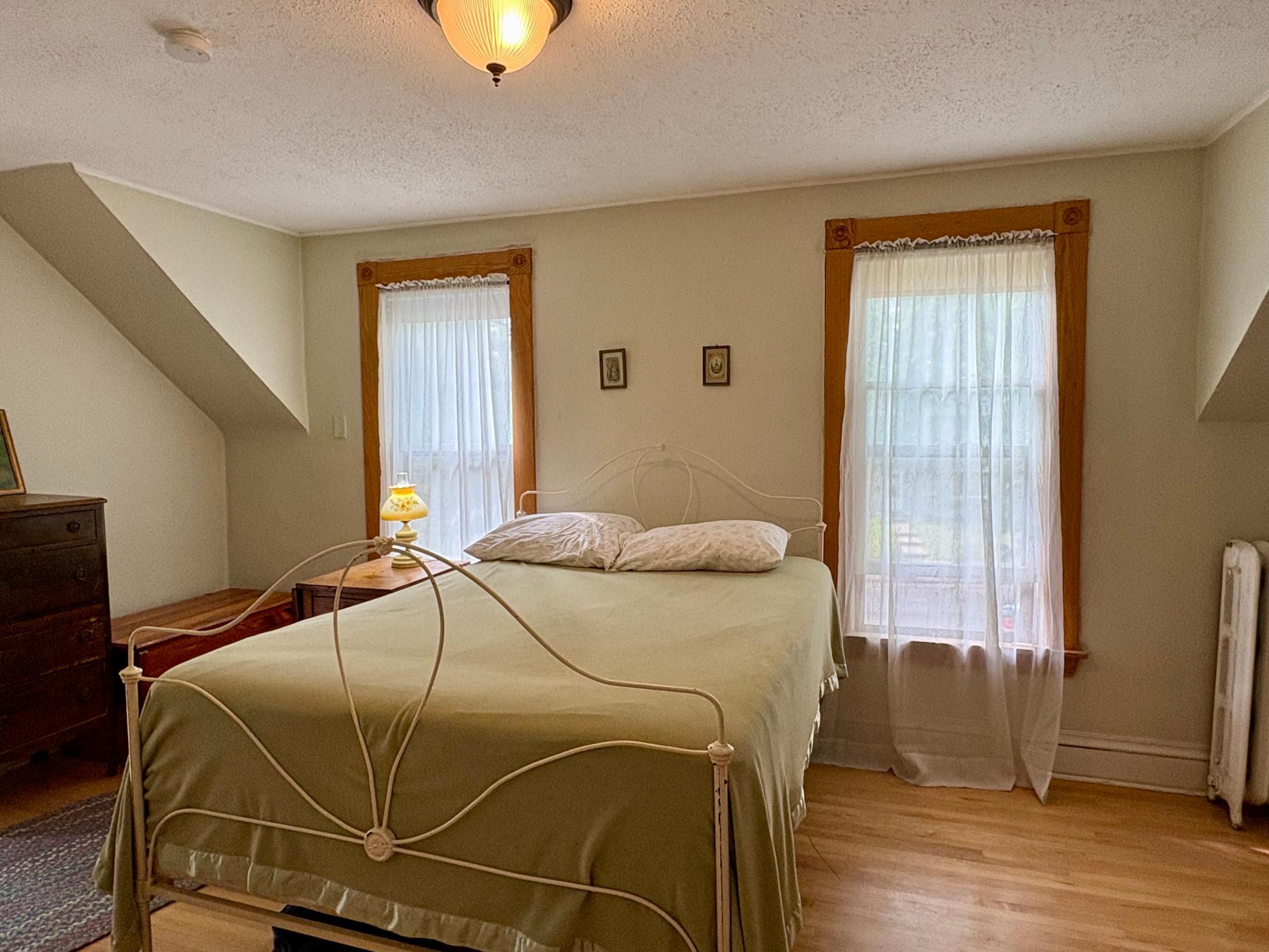 Primary bedroom has large closet and walks up to attic