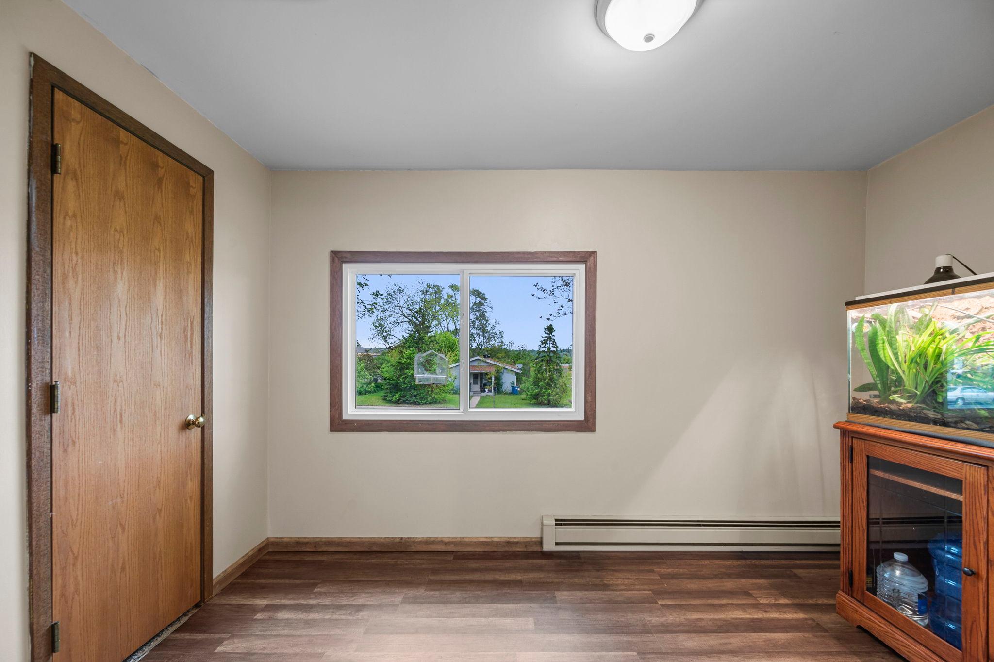Main floor bedroom has beautiful hardwood floors -- and would also make a great office!