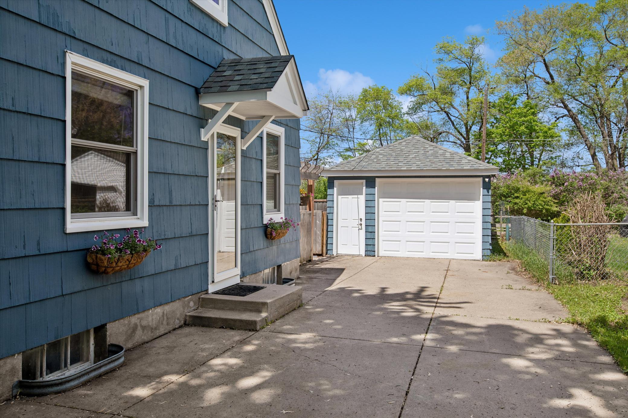Side entrance, backyard access, & garage