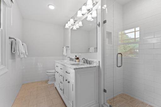 3/4 bathroom with tiled shower and heated floors