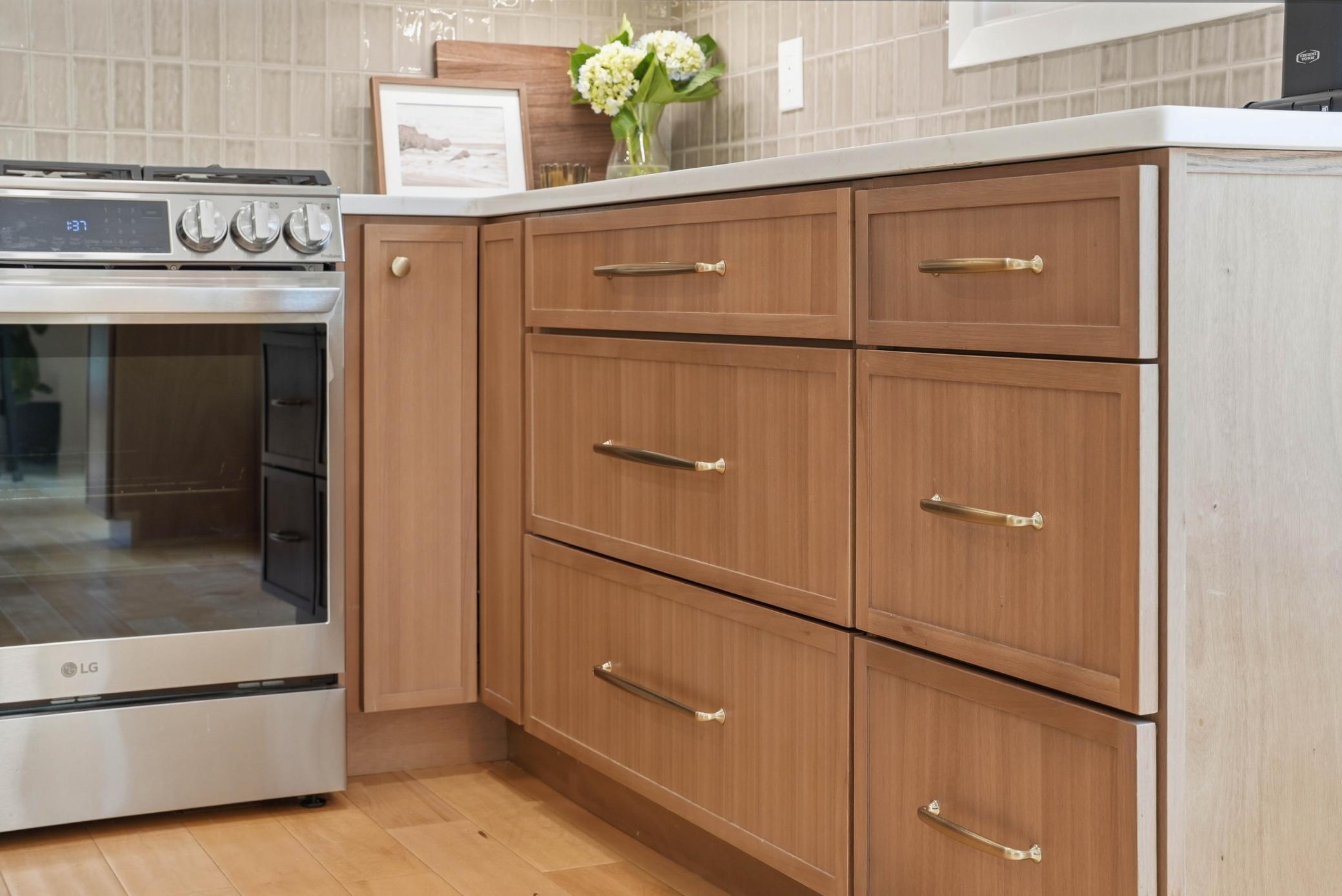 Beautiful natural wood cabinetry and brushed gold hardware