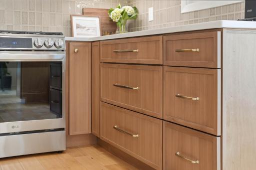 Beautiful natural wood cabinetry and brushed gold hardware