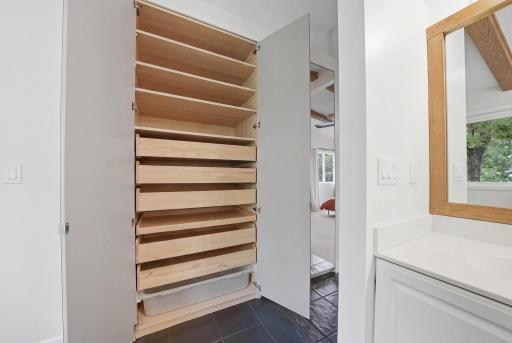Open the mirror to reveal a huge built in closet organizer
