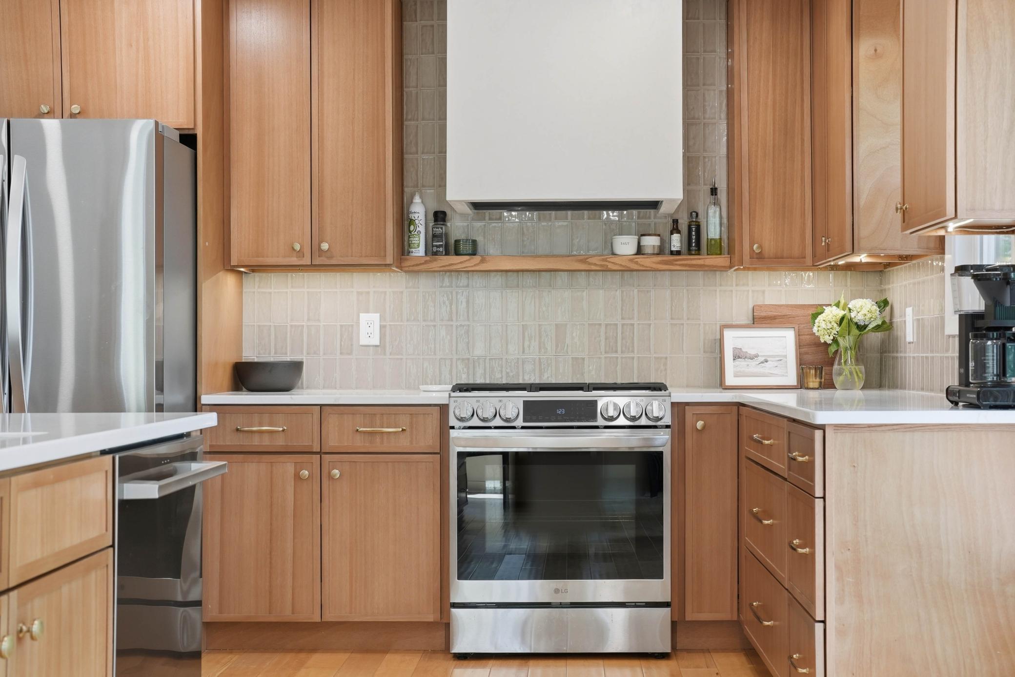 Beautiful tile backsplash with spice rack make a statement