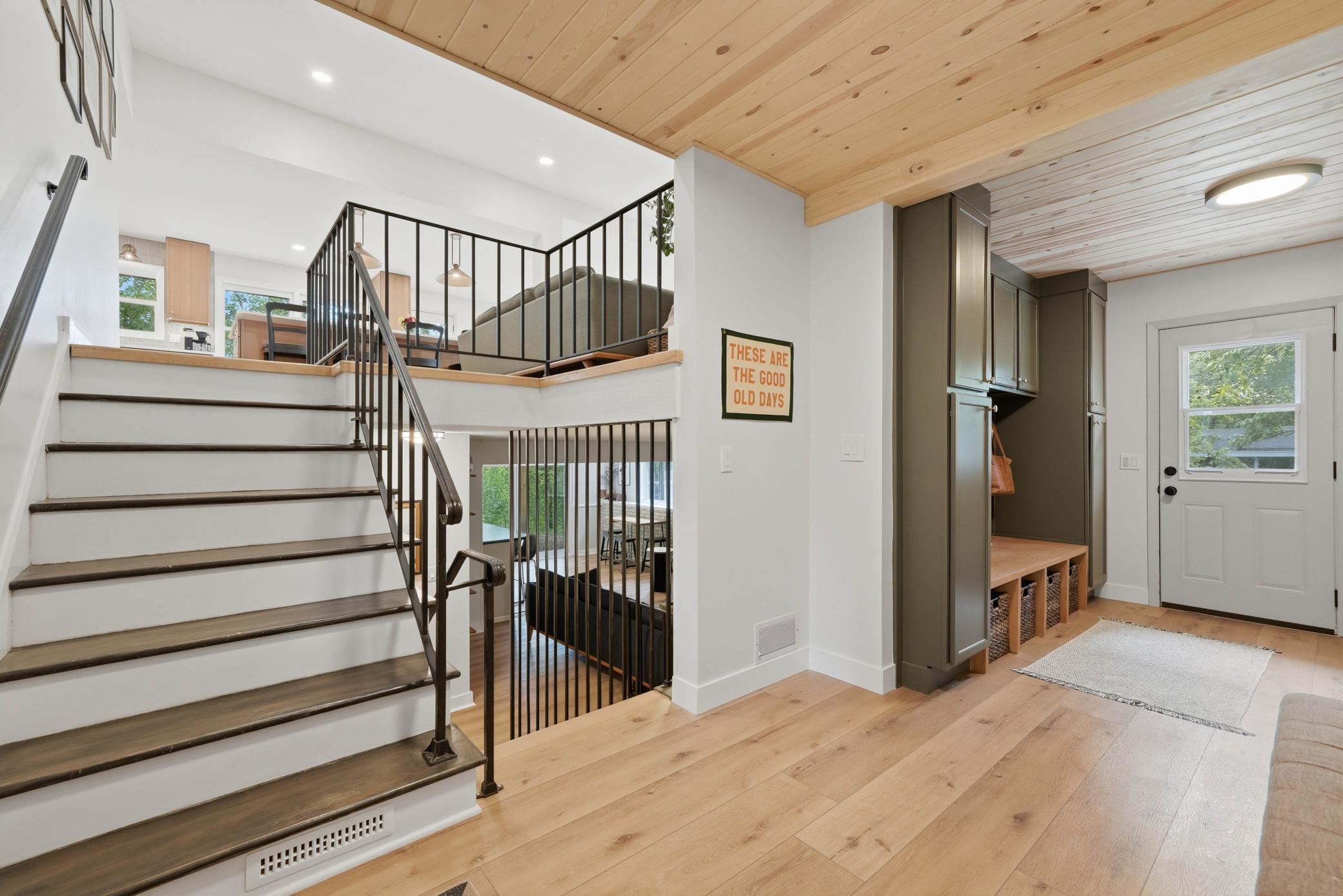 Inviting first impression and newly built mudroom with custom cabinetry.