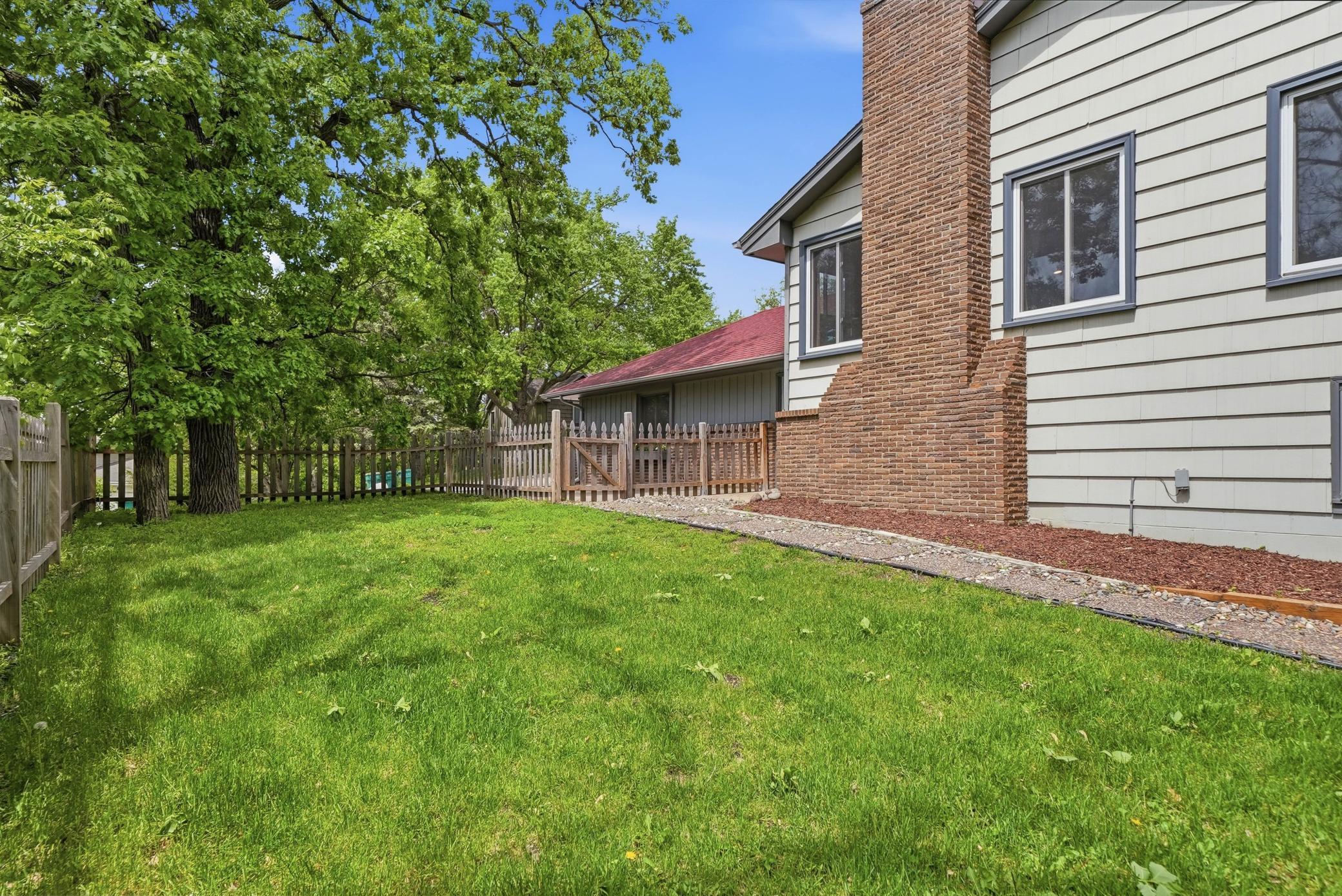 Head out the mudroom off the garage to this fully fenced side yard. Great area separate from backyard that's great for kids or dogs.