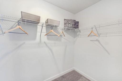 (Photo of decorated model, actual home's finishes will vary) The owner's suite features an incredible walk-in closet.