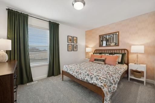 (Photo of decorated model, actual home's finishes will vary) One of three generously sized secondary bedrooms.
