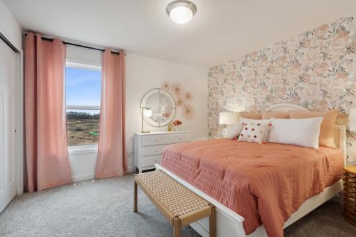 (Photo of decorated model, actual home's finishes will vary) One of three generously sized secondary bedrooms.