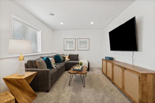 (Photo of decorated model, actual home's finishes will vary) The recreation room can function as the ultimate entertainment space and at-home movie theater.