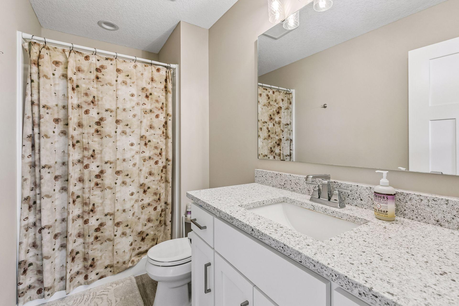 Primary bathroom with a lovely vanity that has storage and counter space for your necessities.